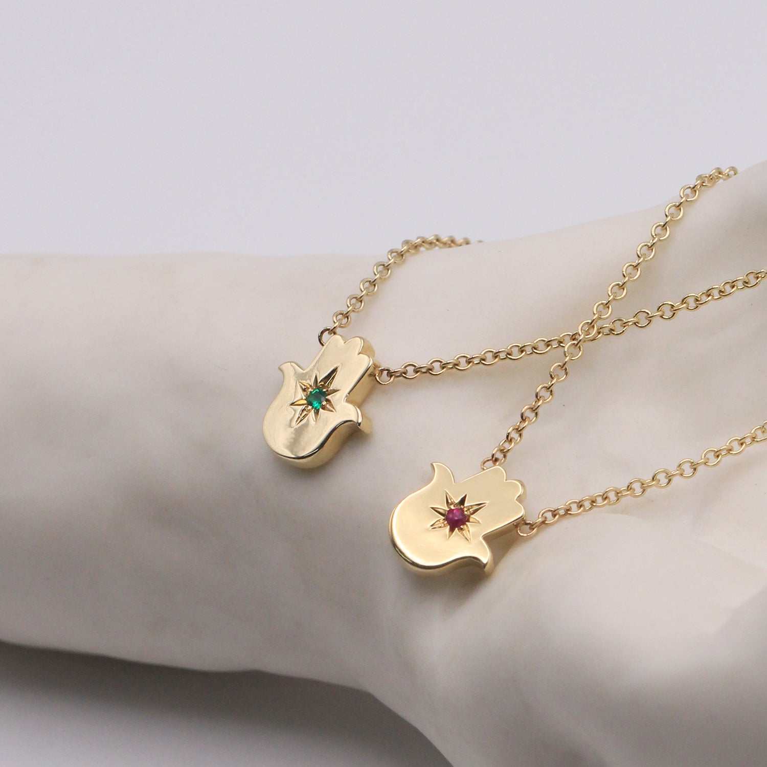 Floating Hamsa gold necklace with Emerald