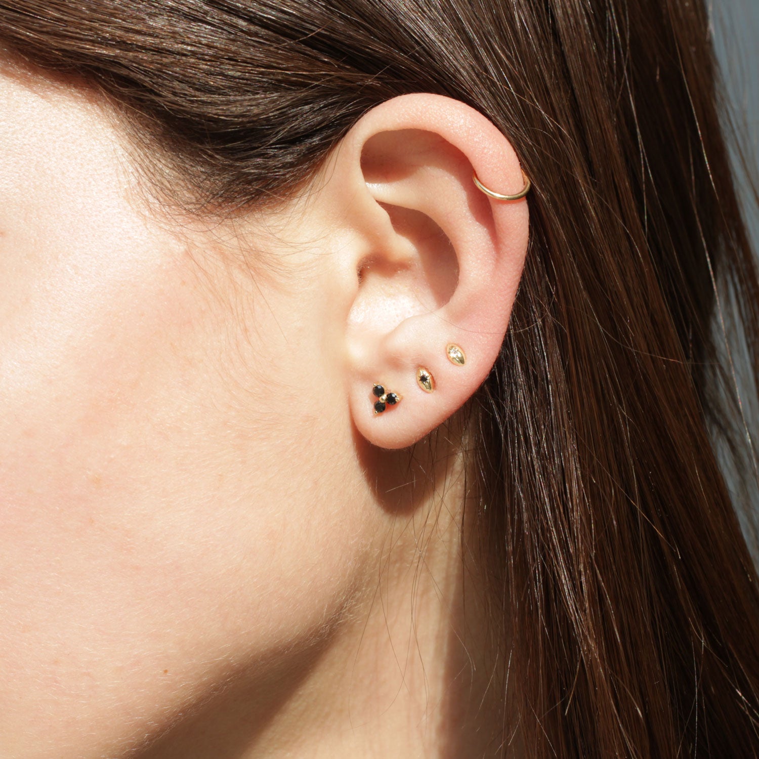 14 gold football earring with black diamond