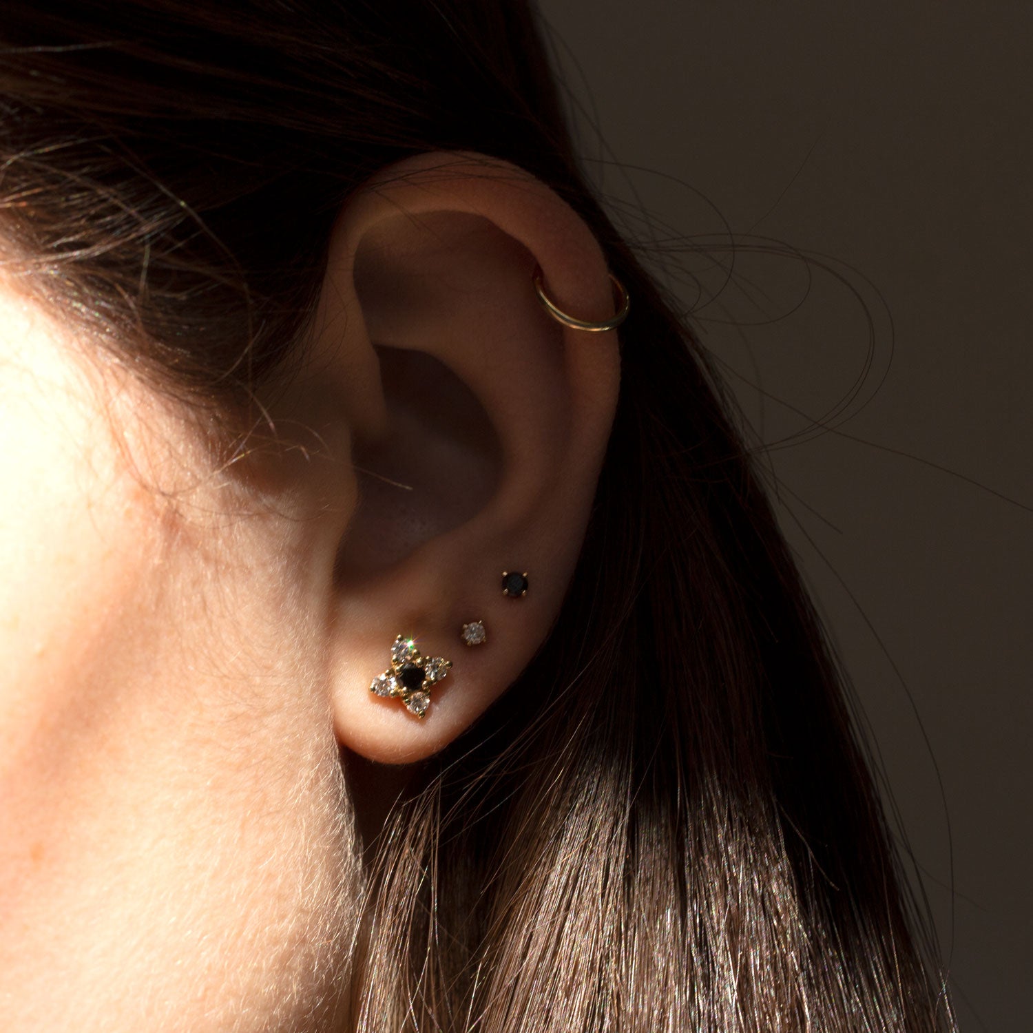 gold flower earrings with black and white diamonds