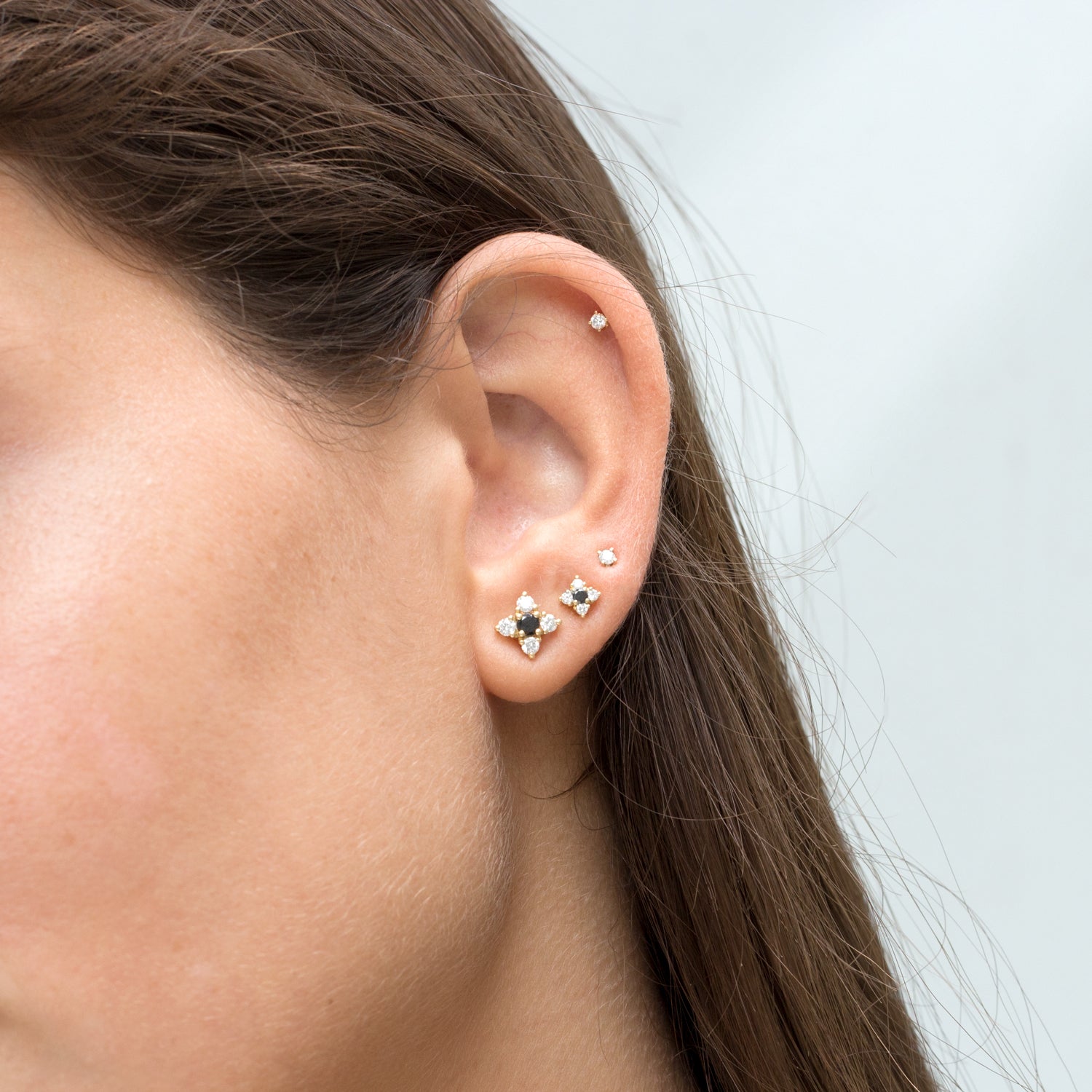 flower shaped earrings with black and white diamonds