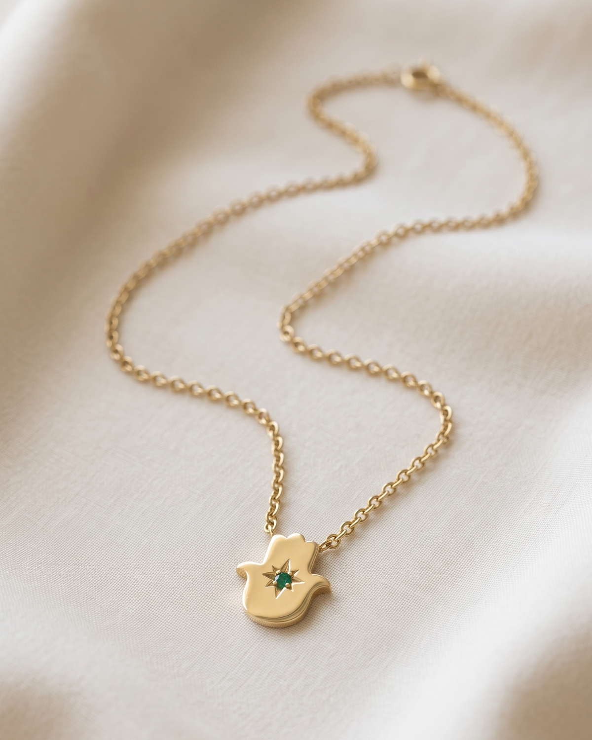 Floating Hamsa gold necklace with Emerald