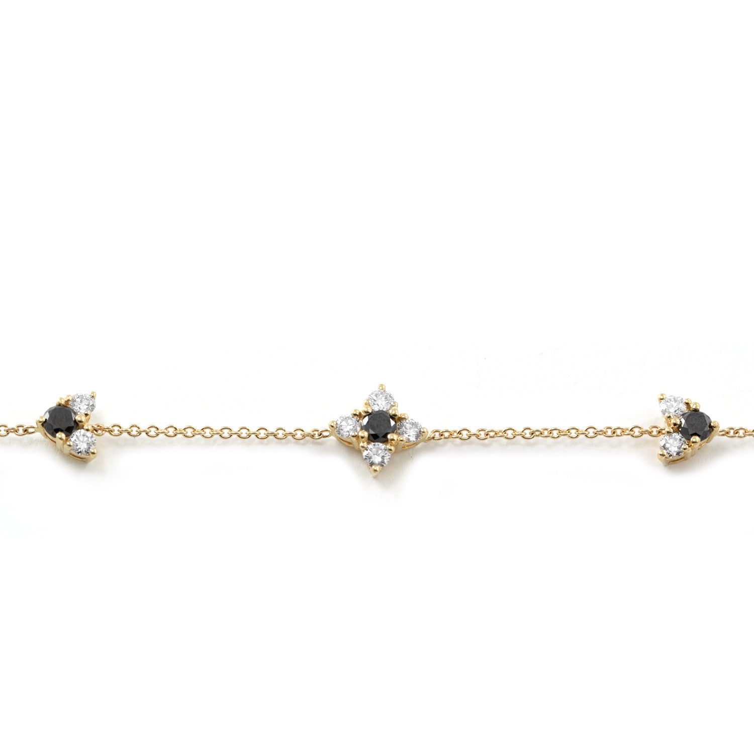 gold bracelet with black and white diamonds