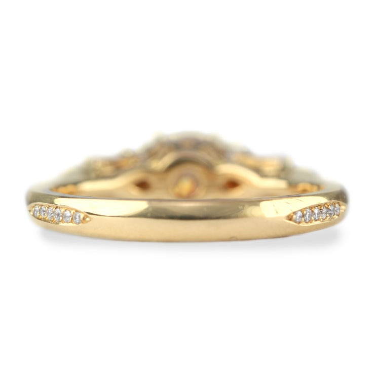 gold engagement ring with pear and round diamonds