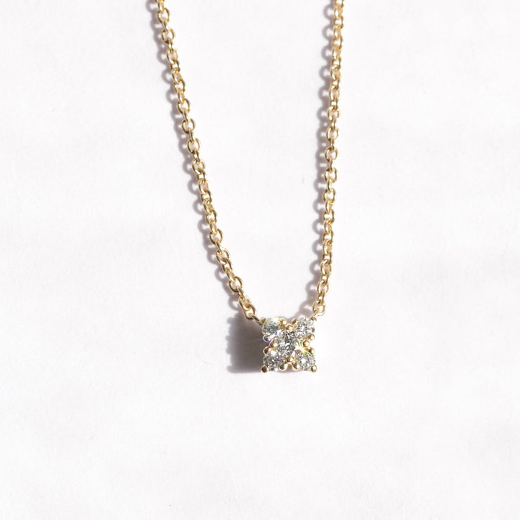 gold necklace with five round diamonds