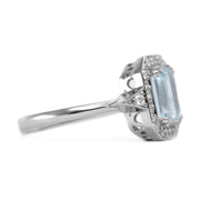 gold halo engagement ring with aquamarine and diamonds